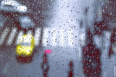 Full frame shot of wet glass window in rainy season