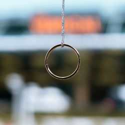 Close-up of hanging light against sky