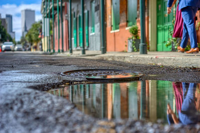 Reflection of building in puddle on street