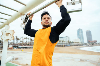 Portrait of young man exercising in city