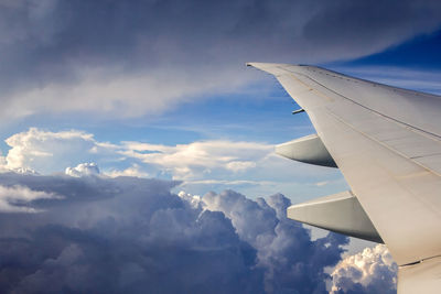 Aerial view of cloudscape over airplane wing