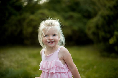 Portrait of cute girl smiling outdoors