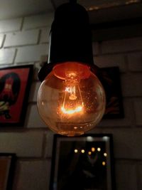 Low angle view of illuminated light bulb at home