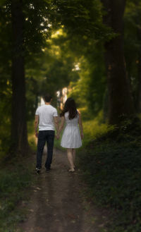 Rear view of couple walking in park