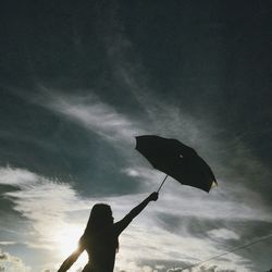 Low angle view of person holding umbrella