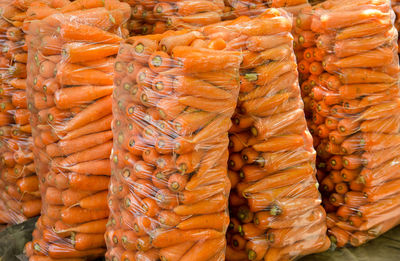 Bags with young fresh carrot prepared for sale. freshly harvested carrots.