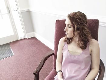 Young woman relaxing on chair at home