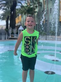 Full length of happy boy in swimming pool