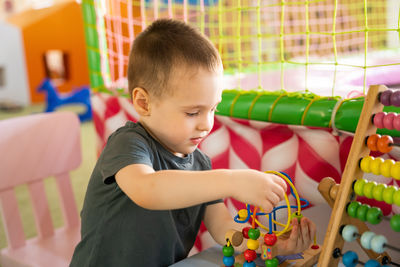 Close-up of boy playing with toy