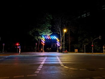 Illuminated city street during rainy season at night