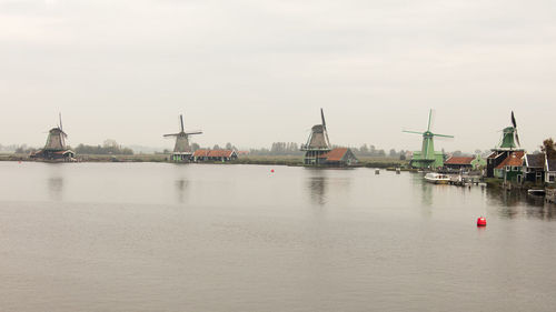 Commercial dock by river against sky