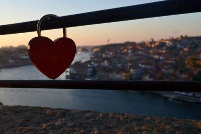 Close-up of padlocks on railing against river