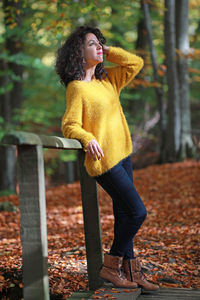 Full length of woman standing in forest