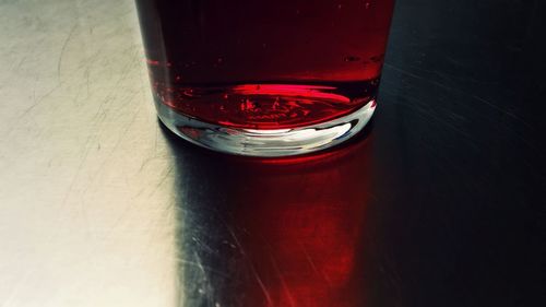 Close-up of red wine in glass on table