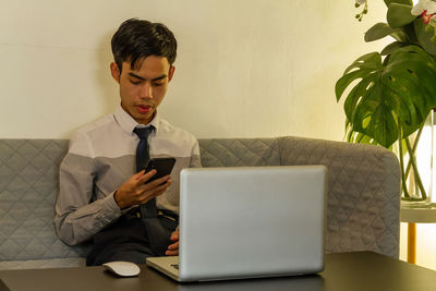 Businesswoman using laptop on table