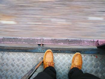 Low section of man standing on railroad track