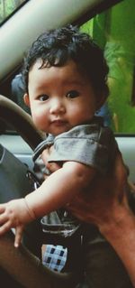 Portrait of cute boy holding car