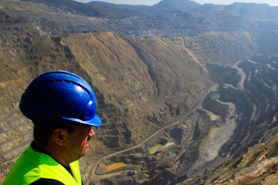 Engineer wearing hardhat on mountain 