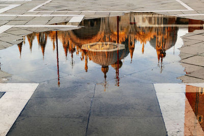 Reflection of building in puddle