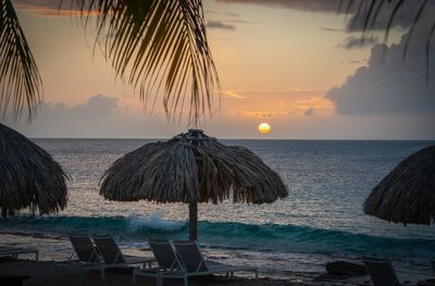 Scenic view of beach against sky during sunset