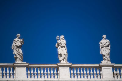 Low angle view of statue against clear blue sky