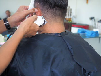 Hairdresser hairstyling male customer