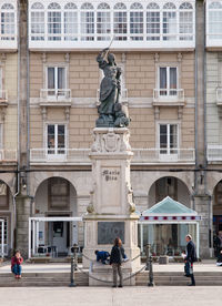 Statue in front of historical building