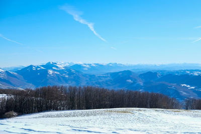 Scenic view of snow covered mountains against sky