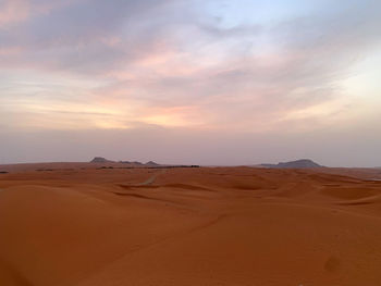 Scenic view of desert against sky during sunset