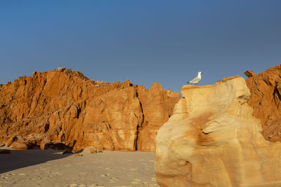 Rock formations against clear blue sky