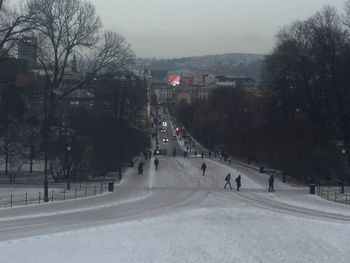 Snow covered city against sky