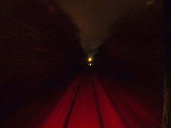 Illuminated tunnel at night