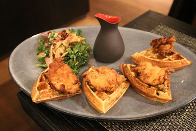 High angle view of chicken with waffles served in plate on table