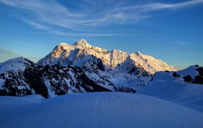 Scenic view of snow covered mountains against sky