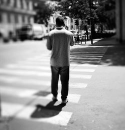 Rear view of man walking on street