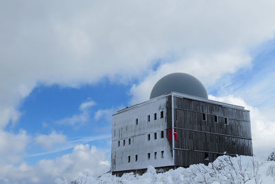 Low angle view of building against sky during winter