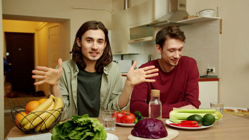 Young man and fruits in restaurant at home