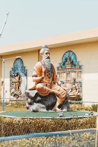 Low angle view of statue against wall