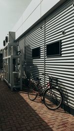 Bicycle parked on street by building