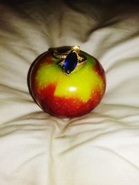 High angle view of apple on bed