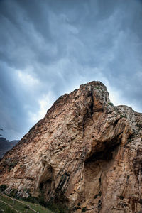 Low angle view of rock formation against sky