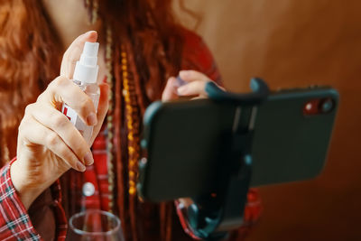 Close-up of woman holding mobile phone