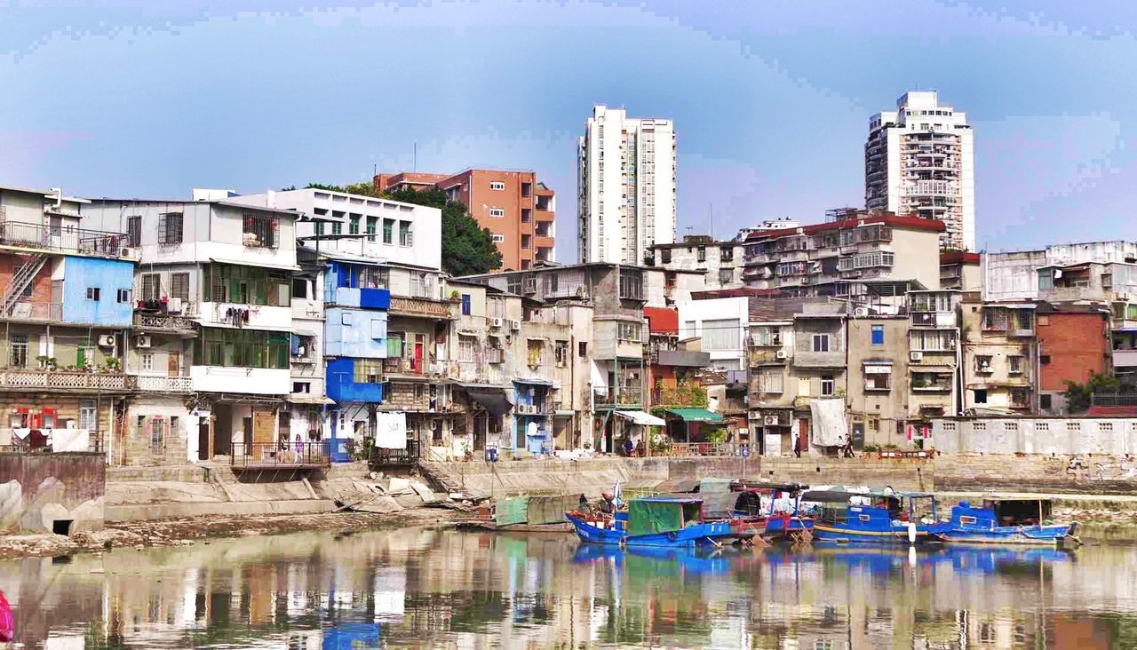 building exterior, architecture, water, built structure, waterfront, blue, reflection, sky, residential building, residential structure, building, nautical vessel, house, day, city, outdoors, boat, incidental people, sea, river