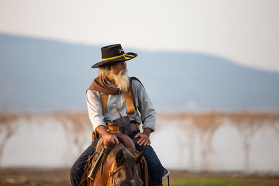 Senior man sitting on horse