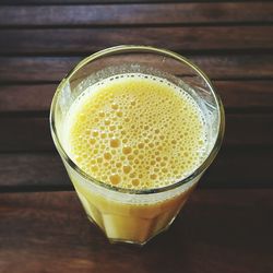 Close-up of served mango juice in glass