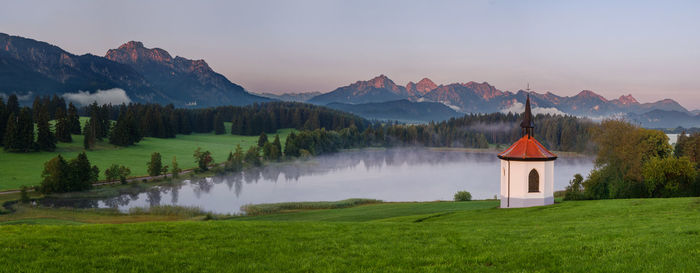 Scenic view of green and mountains against sky
