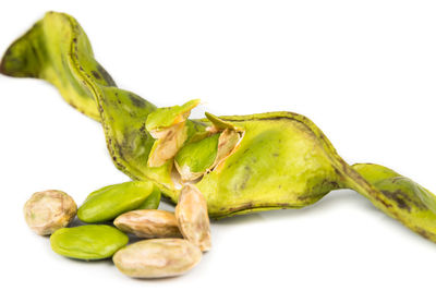 Close-up of green chili pepper against white background