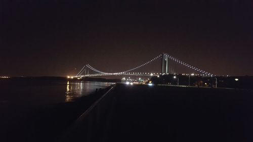 Illuminated suspension bridge at night