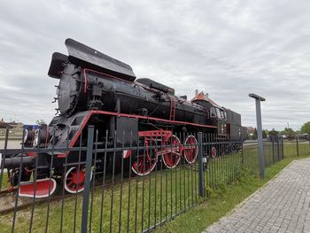 Train on railroad tracks against sky