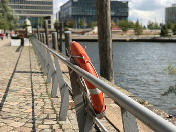 Red boat on river in city